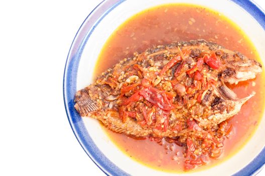 A deep fried fish topped with chili.