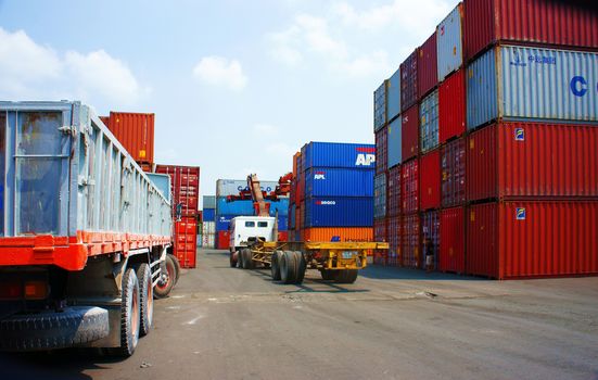 HO CHI MINH CITY, VIET NAM- MAR 19: Truck, trailer, somi load container at freight depot, cargo box in stack, industrial port is logistic service of import, export  goods ,Vietnam, Mar 19, 2014