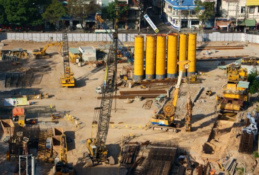 HO CHI MINH CITY, VIET NAM- MAR 23: Overview of construction project, construct equipment as crane, dozer, steel, tractor on work site, urbanisation at development city, Sai Gon, Vietnam, Mar 23, 2014