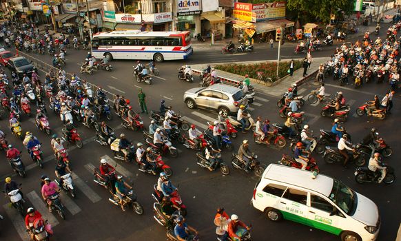HO CHI MINH CITY, VIET NAM- MAR 27:  Chaotic, crowded traffic in rush hour, crrowd of citizen transport by motorcycles, Ho chi Minh is big city with young population,  Vietnam, Mar 27, 2014