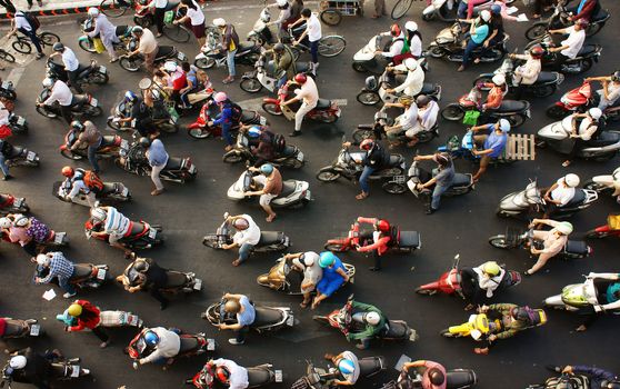 HO CHI MINH CITY, VIET NAM- MAR 27: Dense, crowed  scene of city traffic  in rush hour, crowd of people wear helmet, transport by motorcycles, stop at red light in stress situation, Vietnam, Mar 27, 2014