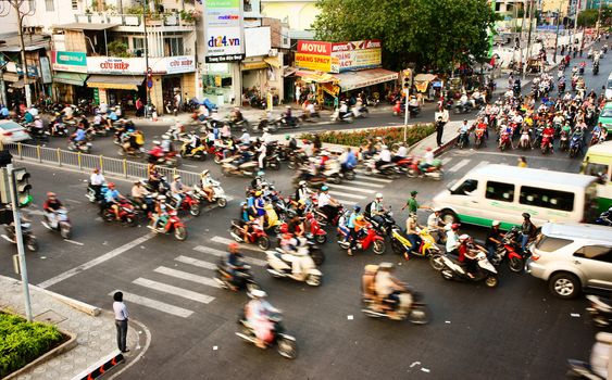 HO CHI MINH CITY, VIET NAM- MAR 27: Vehicle motion blur in urban, group of person wear helmet transfer by motorbike in chaotic, unsafe situation of town traffic, Sai Gon, Vietnam, Mar 27, 2014