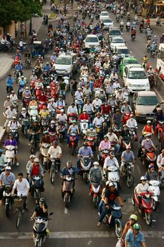 HO CHI MINH, VIET NAM- MAR 27: Crowded atmosphere in rush hour, group of motorbike, big individual vehicle make pressuse on urban traffic, air polution by exhaust fumes, Saigon, Vietnam, Mar 27, 2014