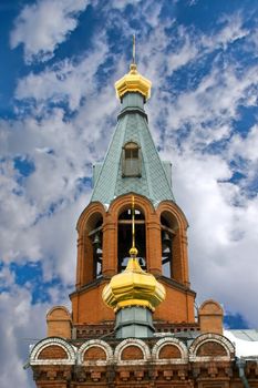 Golden domes on the building of the church against the blue sky.