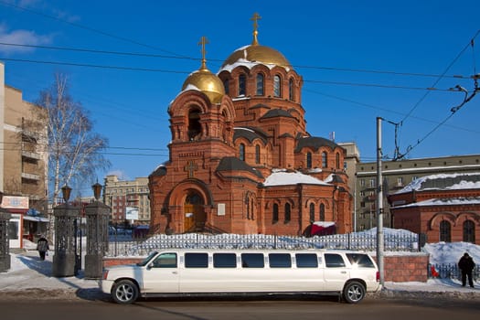 Wedding car parked on road near  church, Russia.