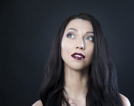 beautiful woman with blue eyes on a black background