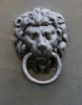 Medieval door knocker black metal lion head.
