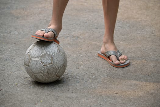 closeup of boy legs play soccer on street