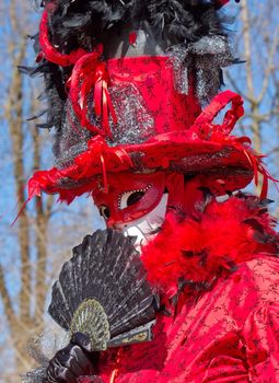 Red female with big hat at the 2014 venetian carnival of Annecy, France