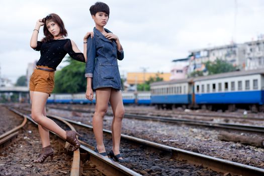 fashion portrait asian two girl in train station.portrait fashion on outdoor.