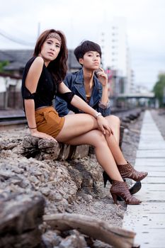 fashion portrait asian two girl in train station.portrait fashion on outdoor.