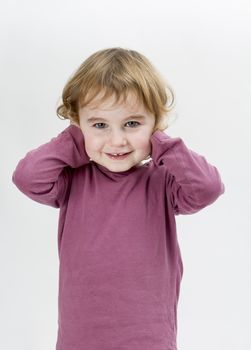 young child covering ears with hands. neutral grey background