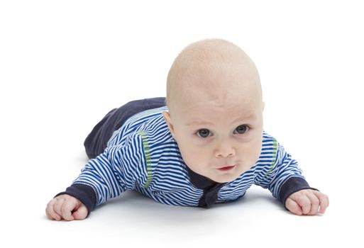 attentive baby laying on ground isolated on white background