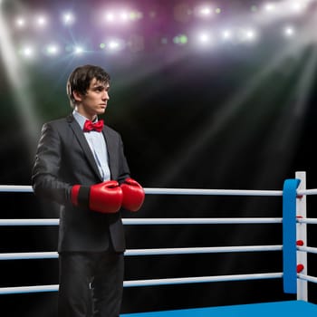 image of a businessman with boxing gloves in the ring, the competition in the business