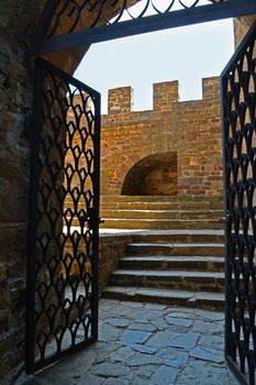 Black steel door in a stone fortress