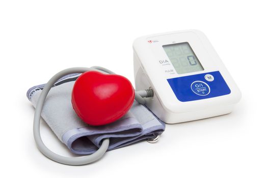 Digital blood pressure meter with love heart symbol on white background 