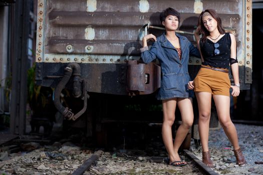 fashion portrait asian two girl in train station.portrait fashion on outdoor.