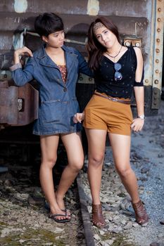 fashion portrait asian two girl in train station.portrait fashion on outdoor.