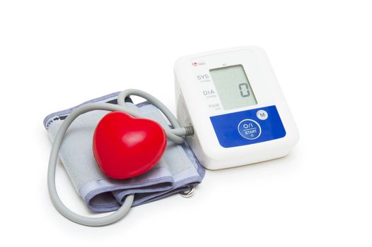 Digital blood pressure meter with love heart symbol on white background