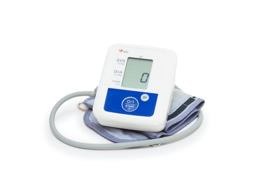 Digital blood pressure meter with love heart symbol on white background