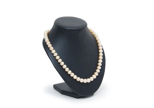 Pearl necklace on black mannequin isolated 