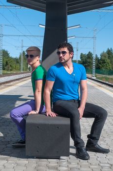 Shot of two handsome guys sitting on platform