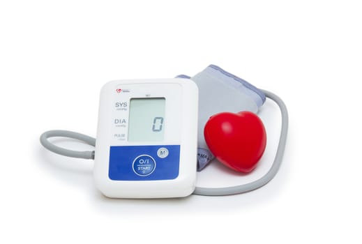 Digital blood pressure meter with love heart symbol on white background 