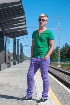 Shot of stylish man with sun glasses standing on platform