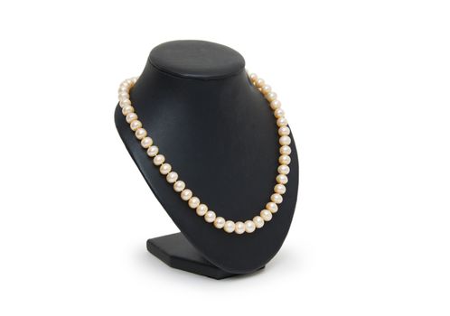 Pearl necklace on black mannequin isolated 