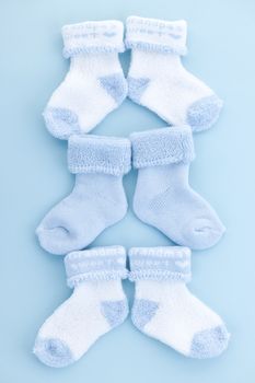 Arrangement of three pairs of blue infant boy socks for baby shower