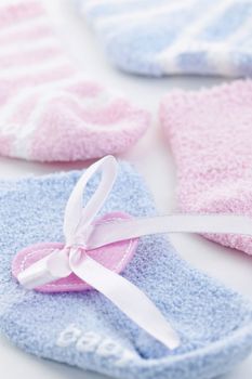 Pink and blue infant socks for baby shower with ribbon