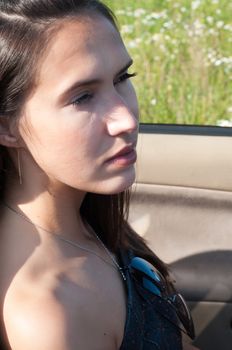 Outdoor shot of beautiful brunette female with long hair