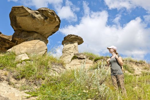 Young girl looking at hoodoos in badlands of Dinosaur provincial park, Alberta, Canada