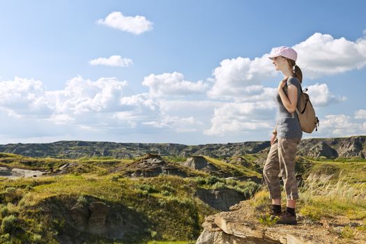 Girl looking at scenic view of the Badlands in Dinosaur provincial park, Alberta, Canada