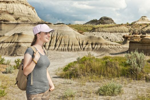 Girl enjoying scenic view at the Badlands in Dinosaur provincial park, Alberta, Canada