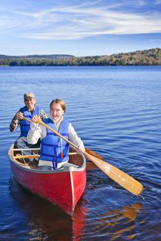 Father and daughter canoeing on Lake of Two Rivers, Ontario, Canada