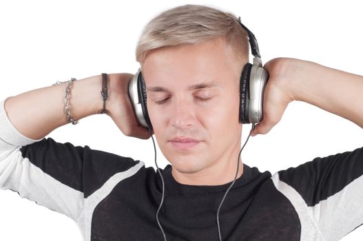 Young blond man in headphones with closed eyes isolated on white