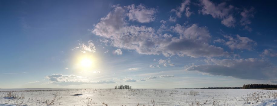 sunset over a snow-covered field in the winter