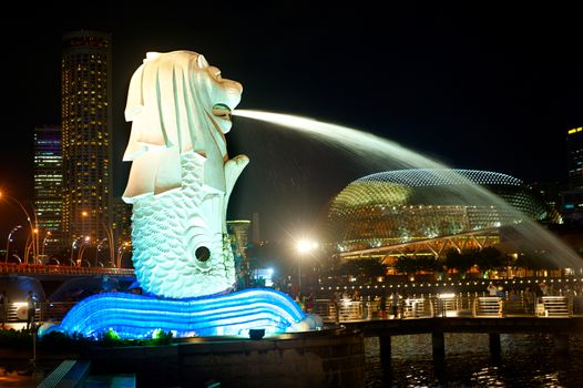 SINGAPORE - MARCH 07, 2013 : The Merlion fountain spouts water in front of Singapore downtown in Singapore. Merlion is an imaginary creature , often seen as a symbol of Singapore