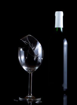 Vine bottle and broken glass on dark background
