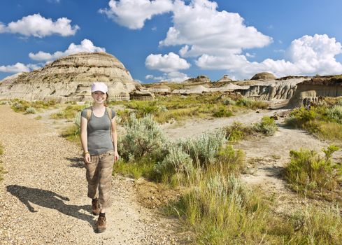 Happy girl hiking the Badlands in Dinosaur provincial park, Alberta, Canada