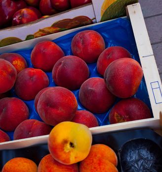 peaches and apricots in the boxes, tropical fruit