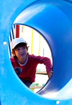 smiling little boy in a baseball cap on the playground