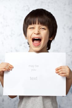 laughing boy  showing  displaying placard ready for your text or product