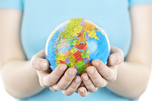 Globe of the planet Earth held in young female hands