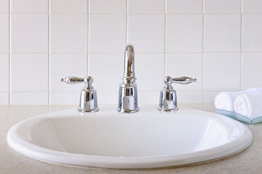 Bathroom interior with white sink and faucet