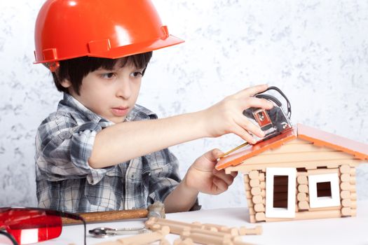 boy builder in red helmet tape measure home