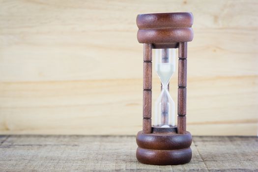 Wood hourglass countdown start on wooden background