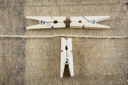 clothespin on rope isolate on wooden background