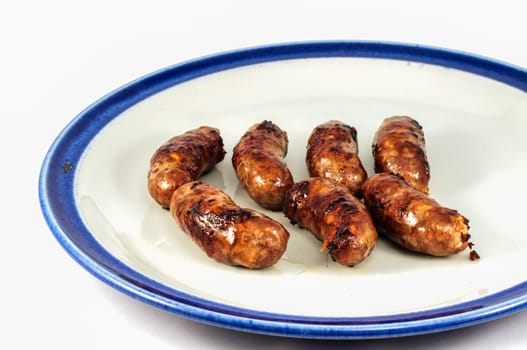 Grill sausages until cooked burnt and black.